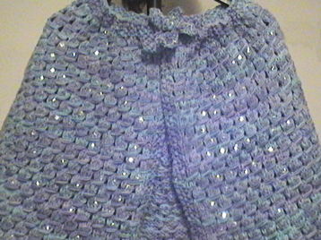 Knitted cape accented with sequins